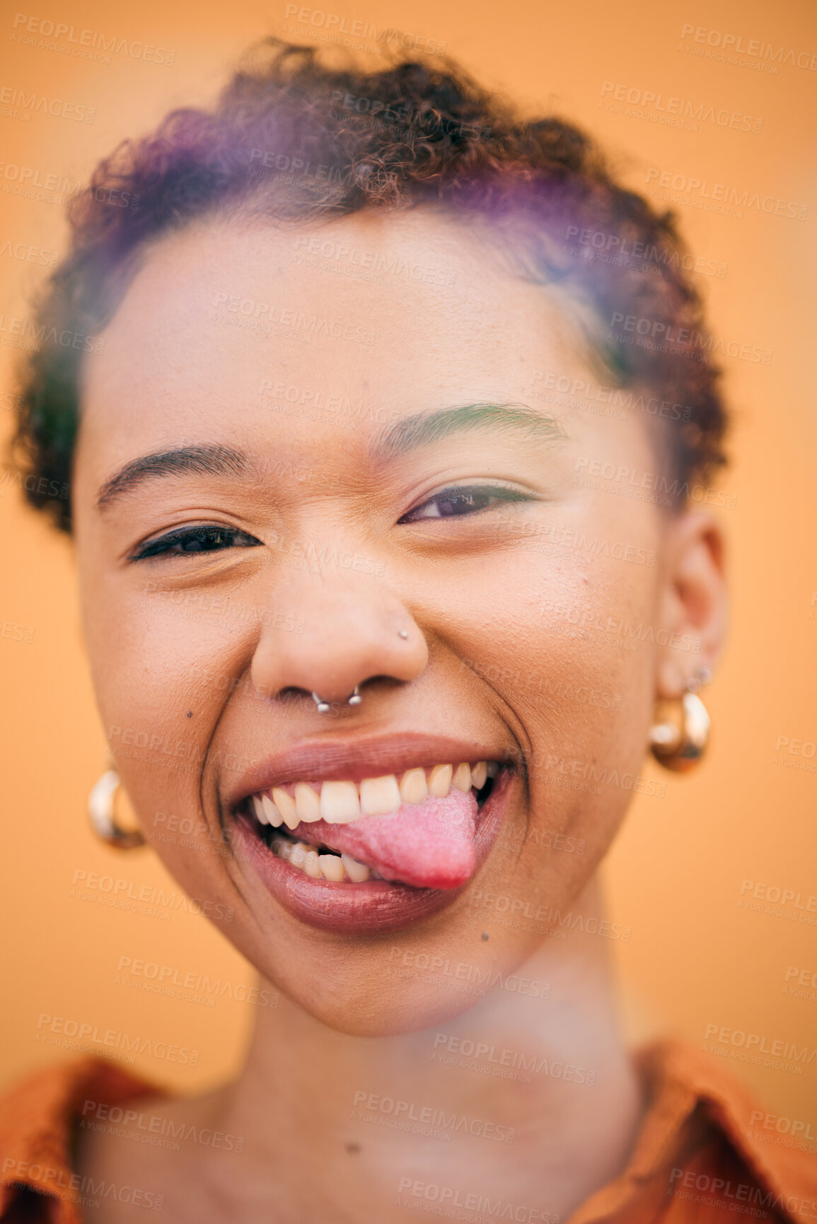Buy stock photo Happy, woman and tongue out face in studio with smile and confidence feeling silly. Orange background, young portrait and African female person with trendy, modern and student fashion with gen z glow