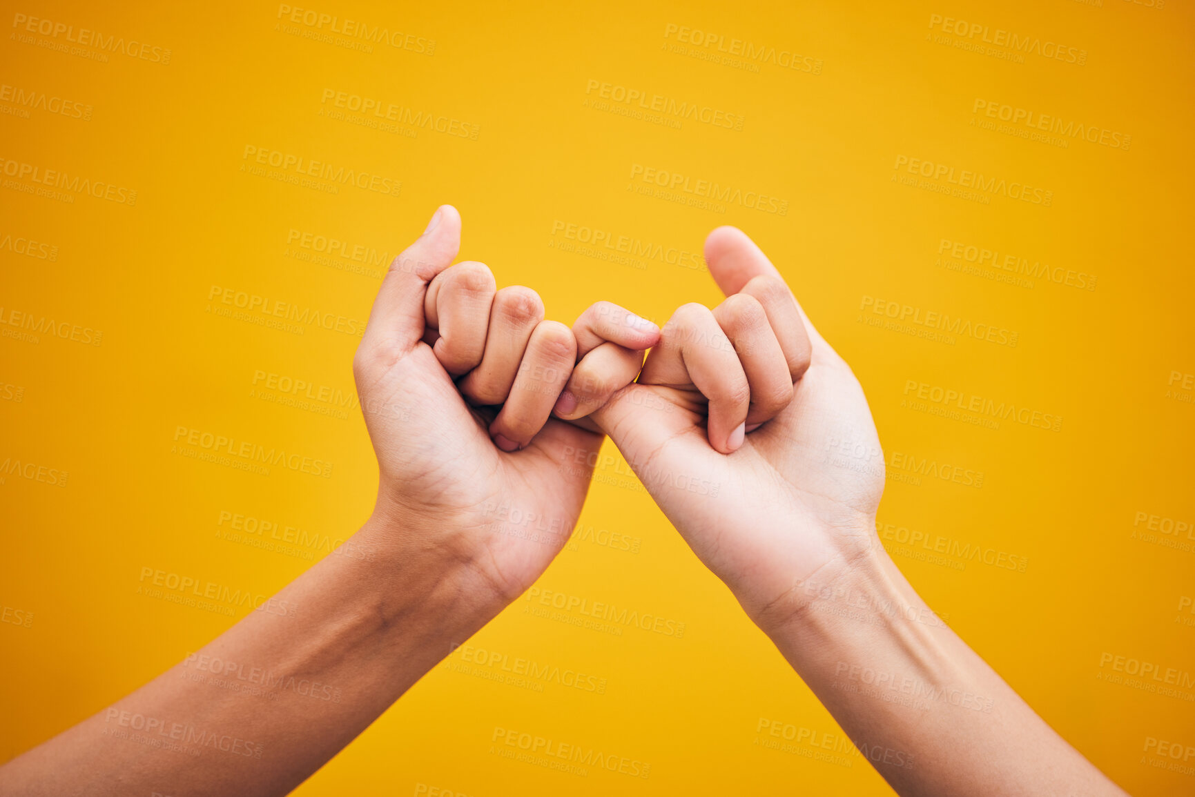 Buy stock photo People, hands and pinky promise in studio with trust, help or hope for reconciliation on yellow background. Finger, emoji and deal by friends with secret, gesture and support expression or solidarity