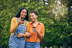 Phone, friends and women in park with coffee together for holiday, bonding and quality time outdoors. Friendship, happy and female people walking in nature for relaxing, conversation and social media