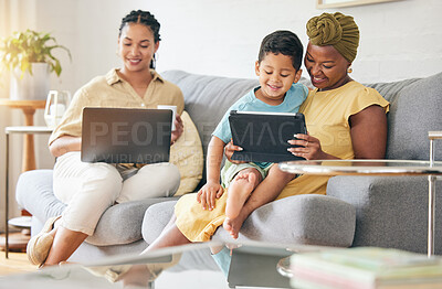Buy stock photo Laptop, tablet and happy family child, mom or bisexual people reading online info, e learning and remote education. Tech app, lesbian mothers and relax gay woman teaching kid on home living room sofa