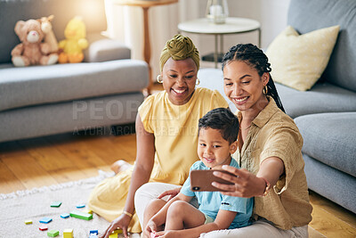 Buy stock photo Lesbian, women and son in home for selfie, smile or care with toys, post or blog on floor in living room. Mother, male kid and happy for gay love, bonding and memory on social network in family house