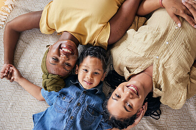 Buy stock photo LGBT, happy portrait and relax family, child or people care, smile and lesbian bond together, lying and on floor carpet. Mothers face, top view kid and non binary parents, homosexual mom or gay women