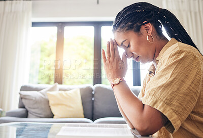 Buy stock photo Bible, worship and woman praying in her living room for hope, help or forgiveness at home. Hands, book and Christian female in prayer for blessing, grace and gratitude to Jesus Christ or God in house