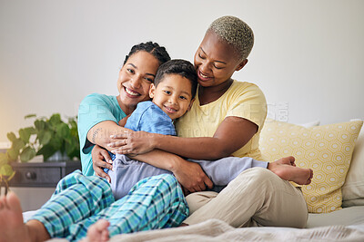 Buy stock photo LGBT, bedroom hug and family portrait, happy child and mothers bond, relax and enjoy time together. Home, bed and gay people, queer parents or lesbian women support, care and hugging adoption kid