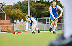 Fitness, workout and female hockey players training for a game, match or tournament on an outdoor field. Sports, exercise and young women playing at practice with a stick and ball on pitch at stadium