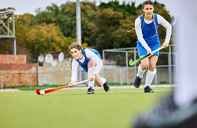 Buy stock photo Fitness, workout and female hockey players training for a game, match or tournament on an outdoor field. Sports, exercise and young women playing at practice with a stick and ball on pitch at stadium