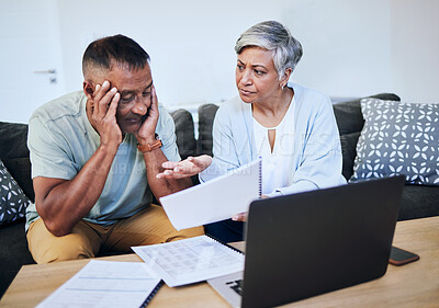 Buy stock photo Frustrated senior couple, documents and laptop in debt, financial crisis or struggle on sofa at home. Upset elderly man and woman in disagreement, argument or fight with finance, bills or expenses
