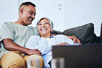 Laugh, relax and mature happy couple on sofa, embrace and funny time in living room of house. Smile, man and woman on couch with comic hug, marriage relationship and fun retirement in home together.