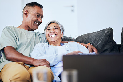 Buy stock photo Laugh, relax and mature happy couple on sofa, embrace and funny time in living room of house. Smile, man and woman on couch with comic hug, marriage relationship and fun retirement in home together.