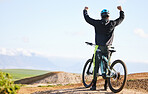Cycling, sports and man celebrate on bicycle for adrenaline on adventure, freedom and success. Mountain bike, nature and cyclist cheer for training, exercise and fitness on dirt road, trail or track