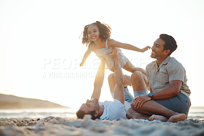 Buy stock photo Lgbt men, child and playing on beach at sunset, airplane games and island holiday together. Love, happiness and sun, gay couple on tropical ocean vacation, parents with daughter on fun picnic on sand