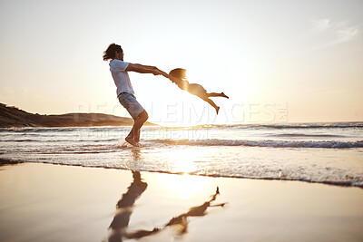 Buy stock photo Father, spin girl kid and beach with games, holding hands or sunset for bonding together by waves. Dad, female kid and swing for love, care or play by sea, silhouette or family on vacation in summer