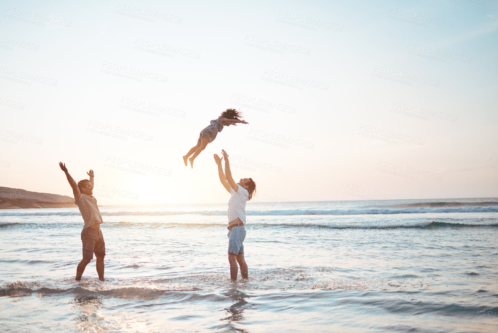 Buy stock photo Father, lifting and child in air at beach, sunset and waves in the ocean for happiness, fun and support on adventure. Parents, kid and silhouette of dad in the sea with love to play a game with girl