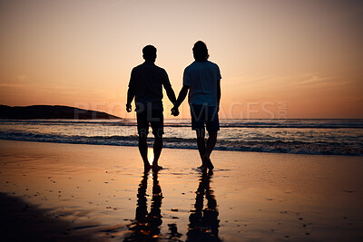 Buy stock photo Silhouette, holding hands and gay men on beach, sunset and shadow on summer vacation together in Thailand. Sunshine, ocean and romance, lgbt couple in nature and fun holiday with pride, sea and sand.