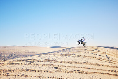 Buy stock photo Desert, bike jump or sports person travel, agile and air trick on sand hill adventure, exercise or training. Motorcycle challenge, sky or extreme athlete risk, freestyle competition or skill training
