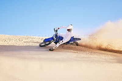 Buy stock photo Bike, sand and sports with a man in the desert for adrenaline, adventure or training in nature. Moto, exercise and dust with a male athlete moving on dunes for freedom, energy or balance in summer