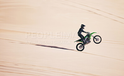 Buy stock photo Bike, sports and balance with a man in the desert for fitness or an adrenaline hobby on space. Motorcycle, training and summer with a male athlete riding a vehicle in Dubai for freedom or energy