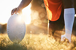 Rugby, ball closeup and sun, sports on field outdoor with bokeh, target with fitness and train for match. Exercise, athlete person hand and game with practice, health and active with player and ready