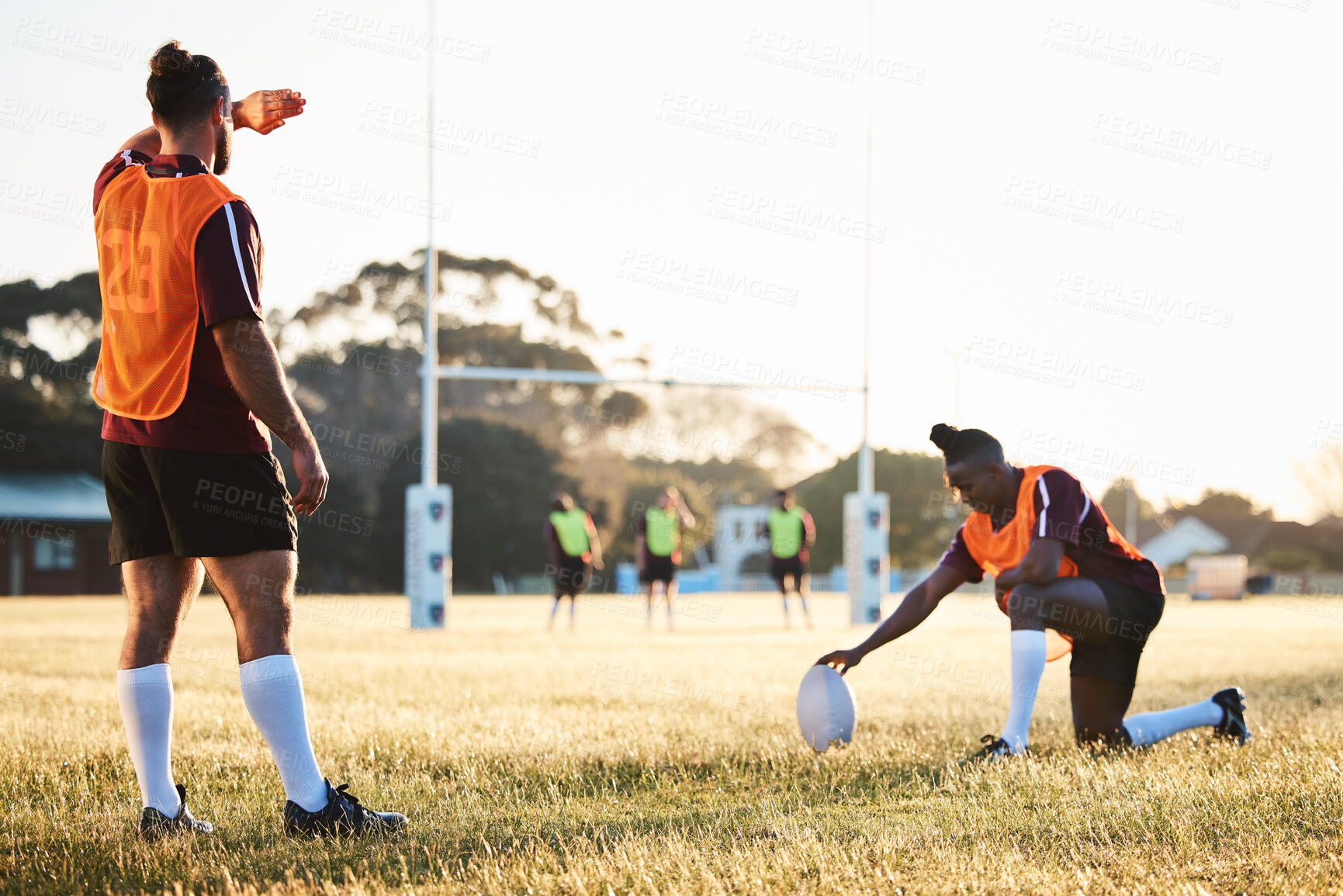 Buy stock photo Rugby, sun and sport game with support, exercise and competition with athlete ball training. Field, back and target practice on grass with cardio, fitness and team workout outdoor for teamwork