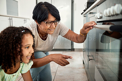 Buy stock photo Baking, oven and a senior woman with her grandchild in the kitchen of a home together for cooking. Family children and an elderly grandmother with a female kid in the house for learning or growth