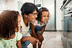 Baking, oven and a senior woman with her grandchildren in the kitchen of a home together for cooking. Family, children and an elderly grandmother with female kids in the house for learning or growth