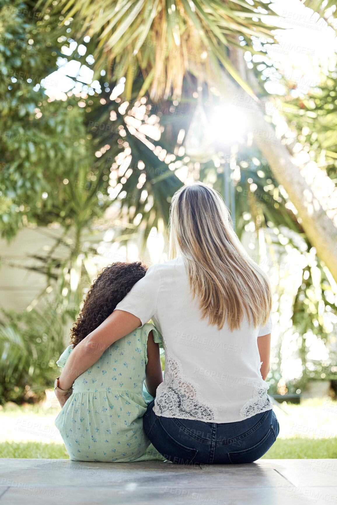 Buy stock photo Child, adoption and together with mom for hug, support or love in backyard, garden or family home of girl in foster care. Interracial, mother and daughter bonding in embrace or sitting outdoor