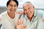 Mature couple, waving and selfie on home sofa for video call, streaming and internet. A happy man and woman together on a couch for social media profile picture, hello or memory of healthy marriage