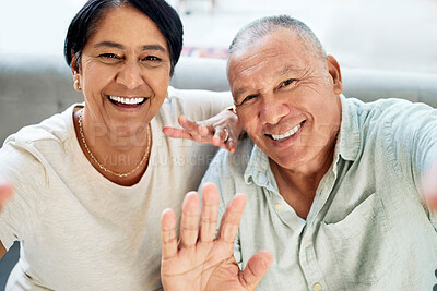 Buy stock photo Mature couple, waving and selfie on home sofa for video call, streaming and internet. A happy man and woman together on a couch for social media profile picture, hello or memory of healthy marriage