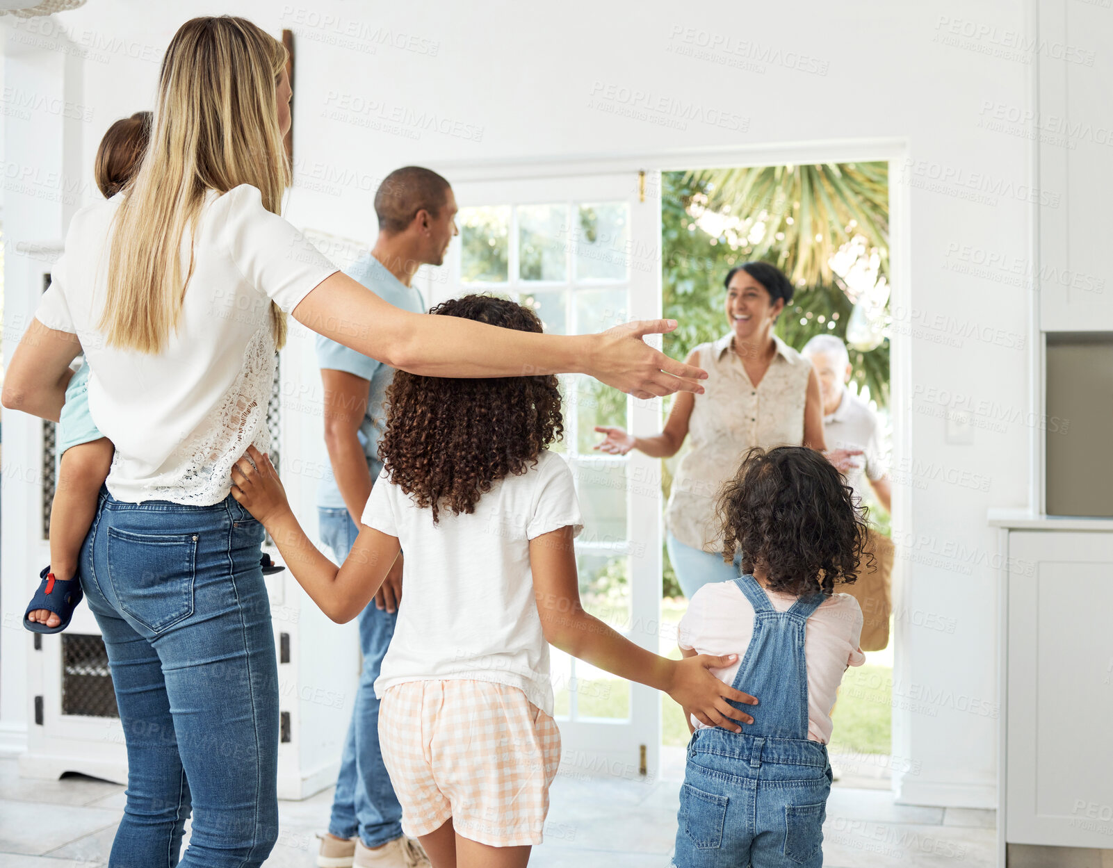 Buy stock photo Happy, home and family welcome grandparents by door excited for bonding, spending time and relationship. Family, hello and grandmother, grandfather and children smile for greeting, visit and arrival