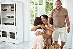 Visit, home and girl hug grandparents by door excited for bonding, spending time and relationship. Family, happy and grandmother, grandfather and child embrace for greeting, welcome and arrival