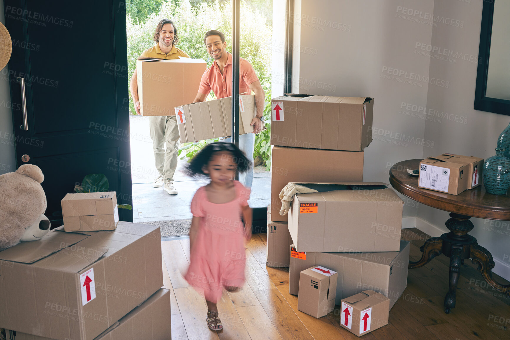 Buy stock photo Happy, family run and box moving with child and gay parents in new home with cardboard package. Smile, kid and lgbt people together with real estate and property love in a house helping father