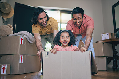 Buy stock photo New home, girl and box with parents, push and gay dad with games, portrait and playing on floor with moving. LGBTQ men, female child and cardboard package for car, airplane or driving in family house