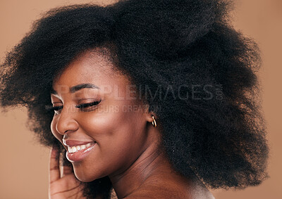 Buy stock photo Beauty, face and hair with a model black woman in studio on a brown background for natural cosmetics. Smile, makeup and haircare with a happy young afro female person indoor for shampoo treatment