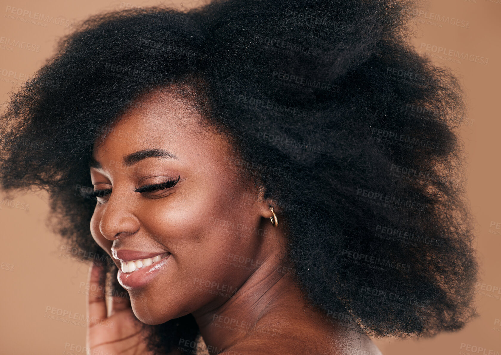 Buy stock photo Beauty, face and hair with a model black woman in studio on a brown background for natural cosmetics. Smile, makeup and haircare with a happy young afro female person indoor for shampoo treatment