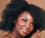 Face, beauty and hair with a model black woman in studio on a brown background for natural cosmetics. Afro, makeup and smile with a happy young female person indoor for organic haircare treatment