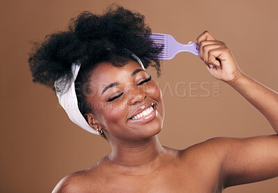 Buy stock photo Comb, hair care or happy black woman with afro, self love or smile on a brown studio background. Hairstyle, healthy growth or African model with natural shine or beauty with aesthetic or wellness