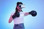 AI, virtual reality and a gamer woman boxing on a blue background in studio for fitness or exercise. Metaverse, sports and training with a young female boxer playing an online fantasy game for health