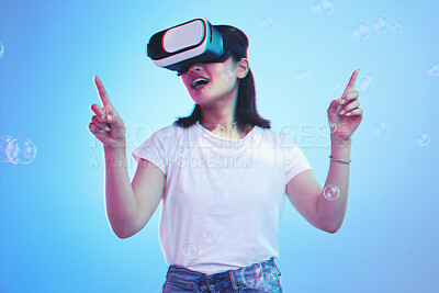 Buy stock photo Woman, virtual reality and glasses for futuristic gaming, metaverse and user experience with high technology. Happy person press bubbles in VR fantasy, 3d vision and scifi on blue, studio background