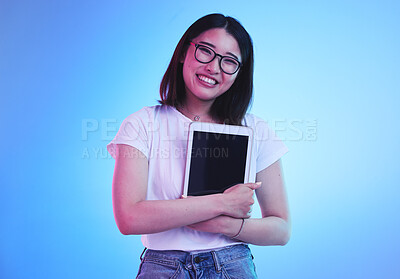 Buy stock photo Young woman, student and tablet mockup for online education, e learning or study on blue, studio background. Asian person with digital technology, marketing space and university information on screen