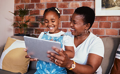 Buy stock photo Happy, African mom and girl on tablet in home, living room and lounge with online education, games and learning technology. Streaming, mobile app or mother and child relax with social media on sofa