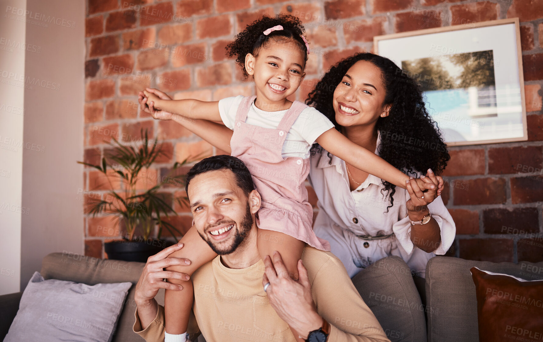 Buy stock photo Family, happy and playing airplane on a home sofa for fun, freedom and time together. Portrait of a man, woman and girl kid in a lounge with love, care or happiness for game in a house in Puerto Rico
