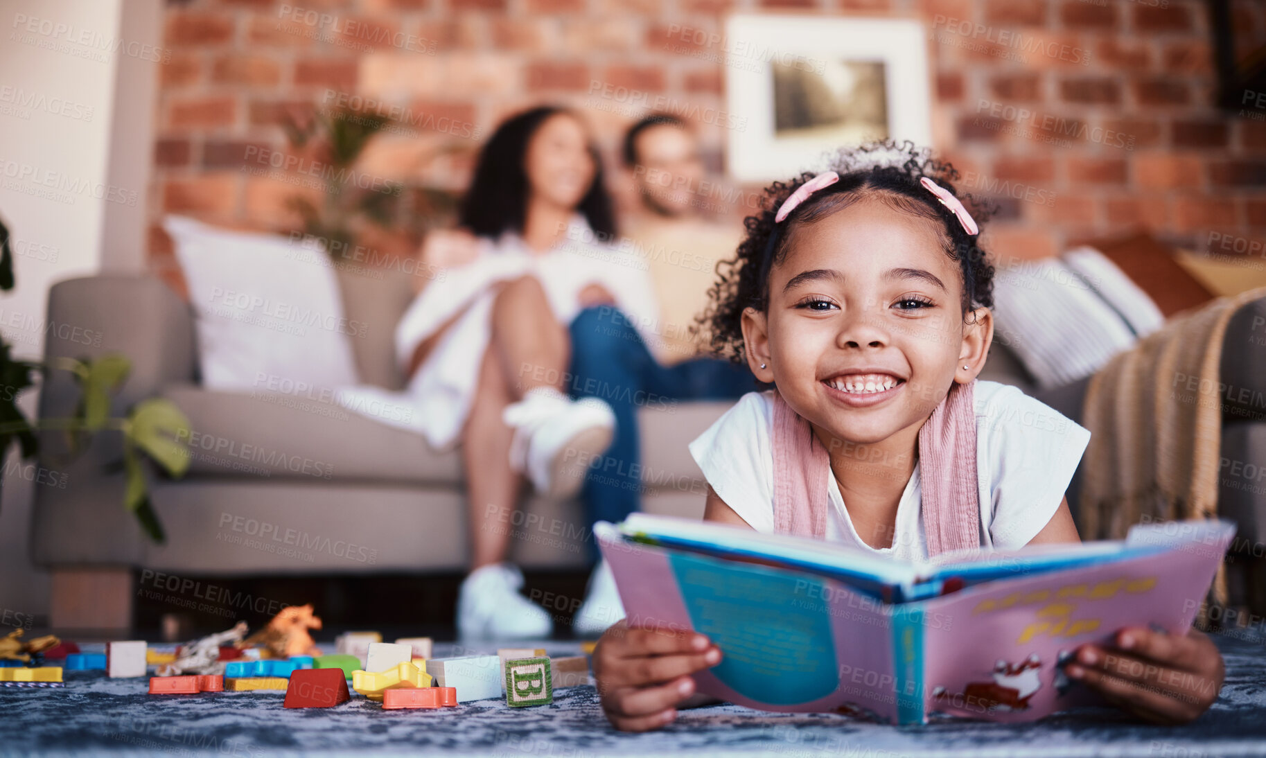 Buy stock photo Home, portrait and girl on the floor, reading book and happiness with knowledge, relax and weekend break. Face, kid and female child in a lounge, parents and story with fun, playful and learning 