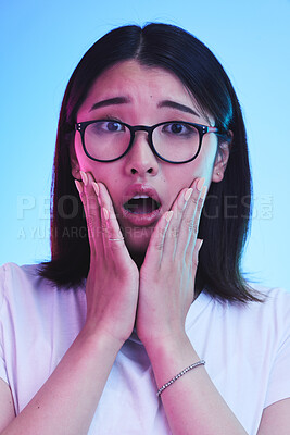 Buy stock photo Surprise, shocked and face of Asian woman with wow expression or open mouth for drama, deal and promotion. Omg, wtf and portrait of person with discount emoji isolated in a studio blue background