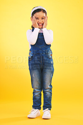 Buy stock photo Fashion, portrait and hands on face of girl child in studio with deal, sale or giveaway on yellow background. Wow, emoji and mind blown kid winner with celebration for coming soon, surprise or prize