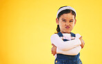 Arms crossed, portrait and angry girl child in studio with bad, attitude or behavior problem on yellow background. Frown, face and asian kid with body language for no, frustrated or tantrum emoji
