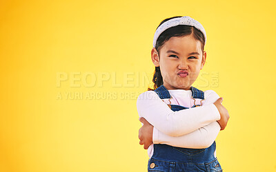 Buy stock photo Arms crossed, portrait and angry girl child in studio with bad, attitude or behavior problem on yellow background. Frown, face and asian kid with body language for no, frustrated or tantrum emoji