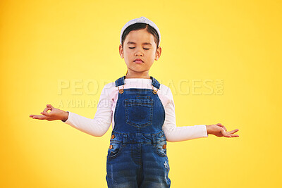 Buy stock photo Lotus, hands and girl child with meditation in studio for wellness, peace or balance on yellow background. Children, mental health and kid with yoga pose for energy training or holistic exercise
