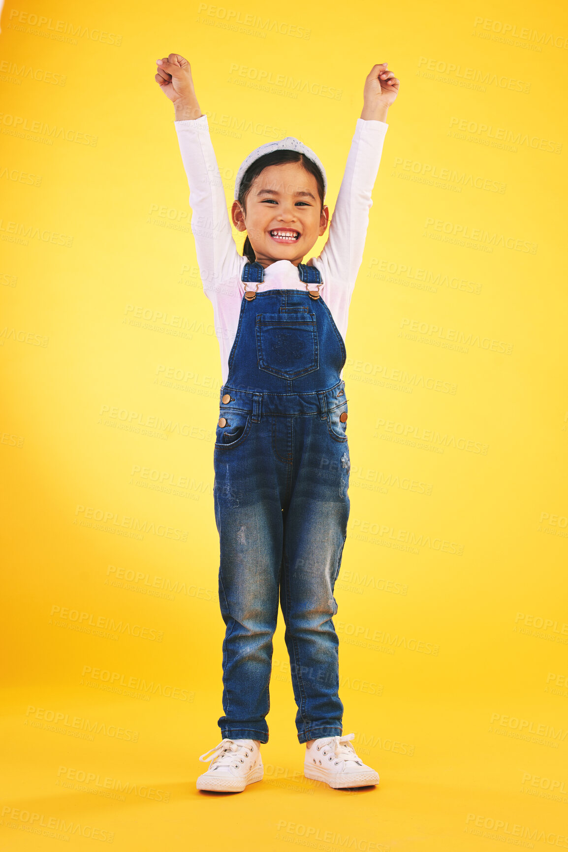 Buy stock photo Portrait, children and a winner girl on a yellow background in celebration of success or victory. Kids, goals and motivation with a young child cheering for an award or achievement in studio