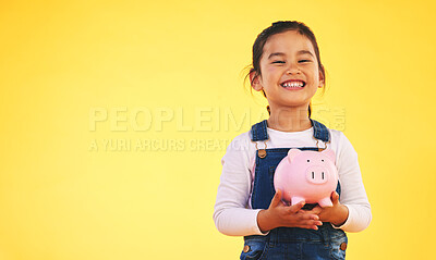 Buy stock photo Girl child, piggy bank and saving in studio portrait with smile, mockup space and excited by yellow background. Young female kid, money box and start investment for promo, financial knowledge or goal
