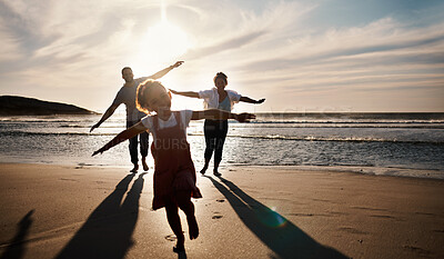 Buy stock photo Family, running and freedom on beach with sunset, shadow and fun together, games and bonding on vacation. Travel, adventure and playful, parents and child with happy people in nature and energy